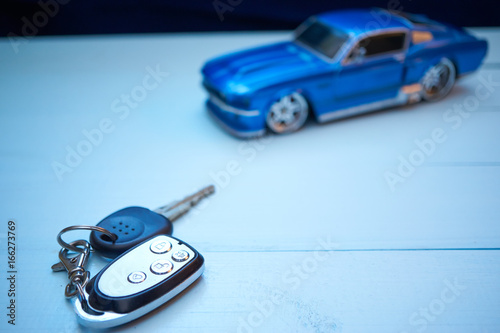 car keys on a desk with toy car