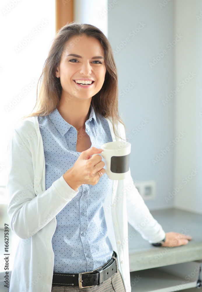 happy woman drinking tea in the kitchen at home. Woman at home happy woman drinking tea in the kitchen at home. Woman at home