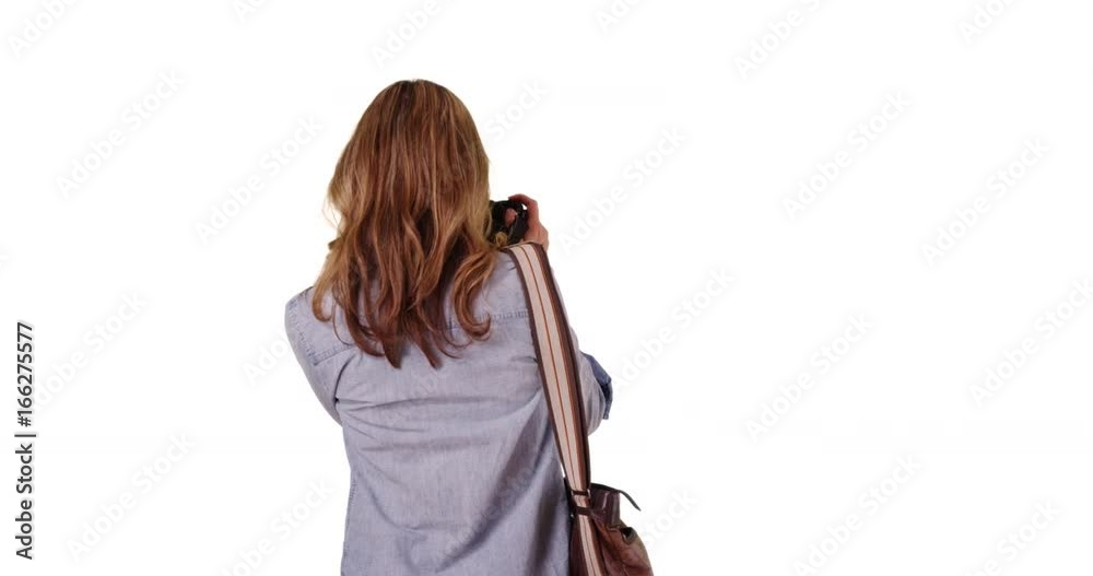Female taking photo with back to camera on white background with copyspace Female taking photo with back to camera on white background with copyspace