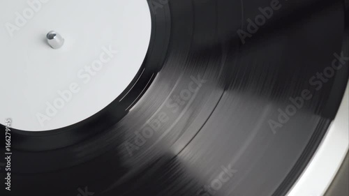 The moment of a spinning vinyl plate. Turntable vinyl record player. Retro audio equipment for disc jockey. Sound technology for DJ to mix & play music. Black vinyl record