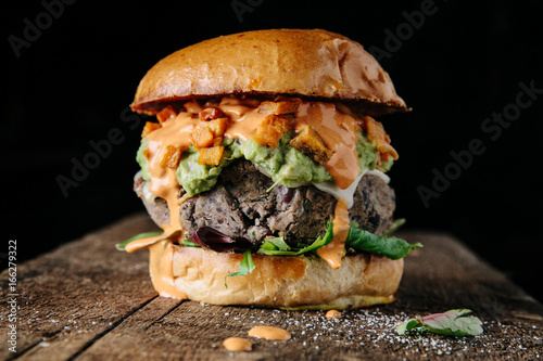 Fresh veggie burger on dark background photo