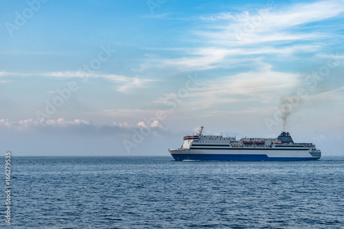 an industrial ship cruising on bohai ocean against blue sky,dalian city,china.