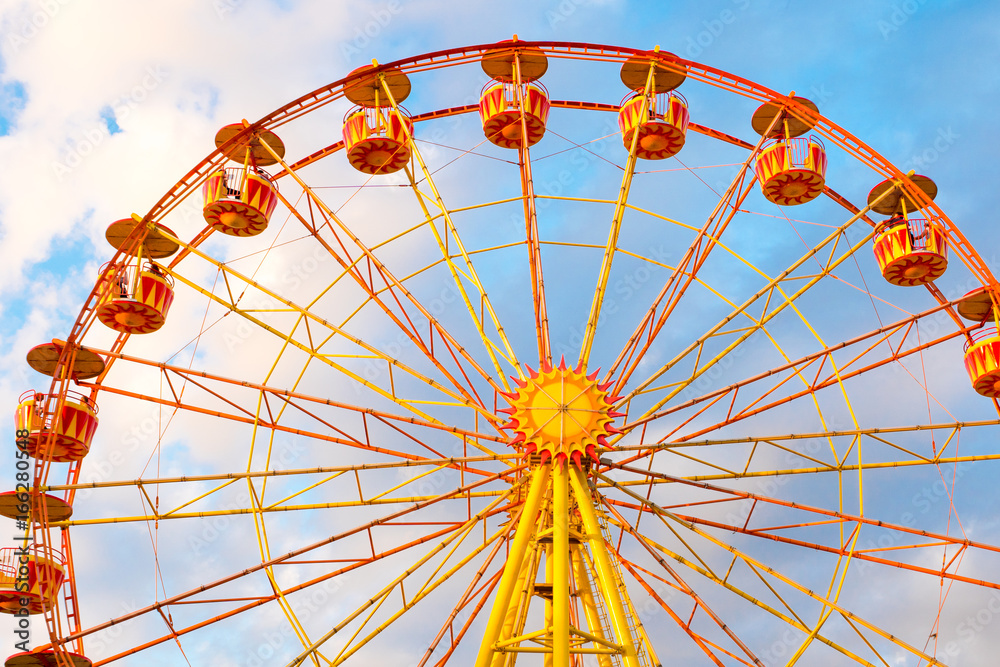 ferris wheel on cloudy sky background