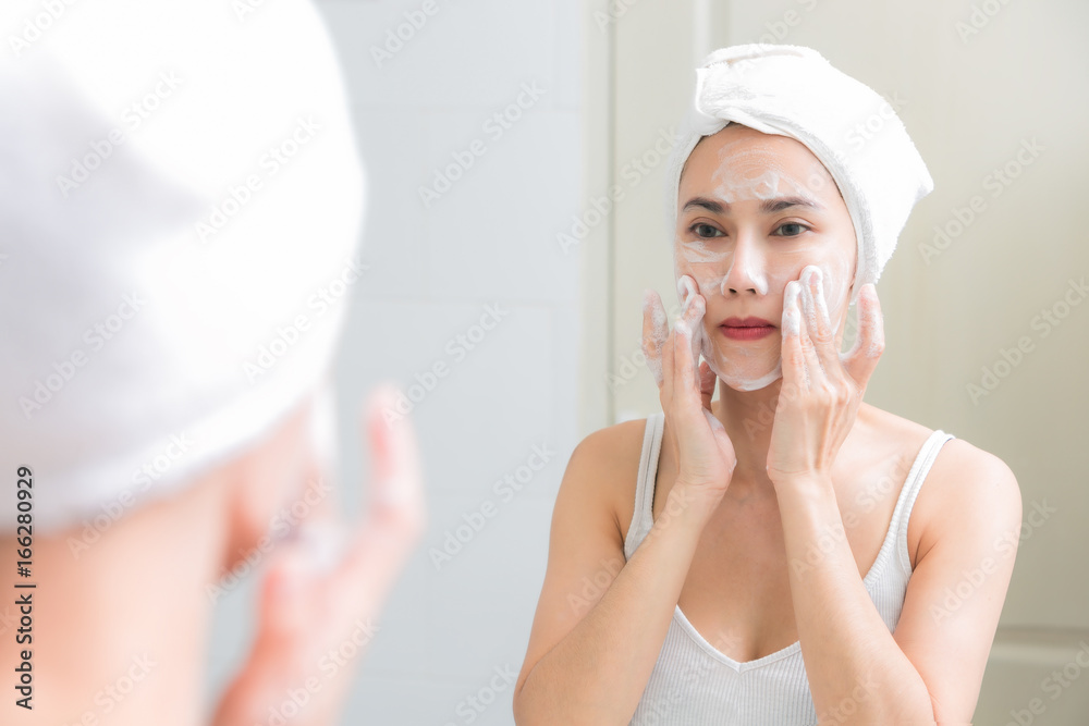 Asian woman cleaning face skin enjoy herself with bubble cleansing foam. Asian woman cleaning face skin enjoy herself with bubble cleansing foam.