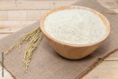 raw rice in wooden bowl