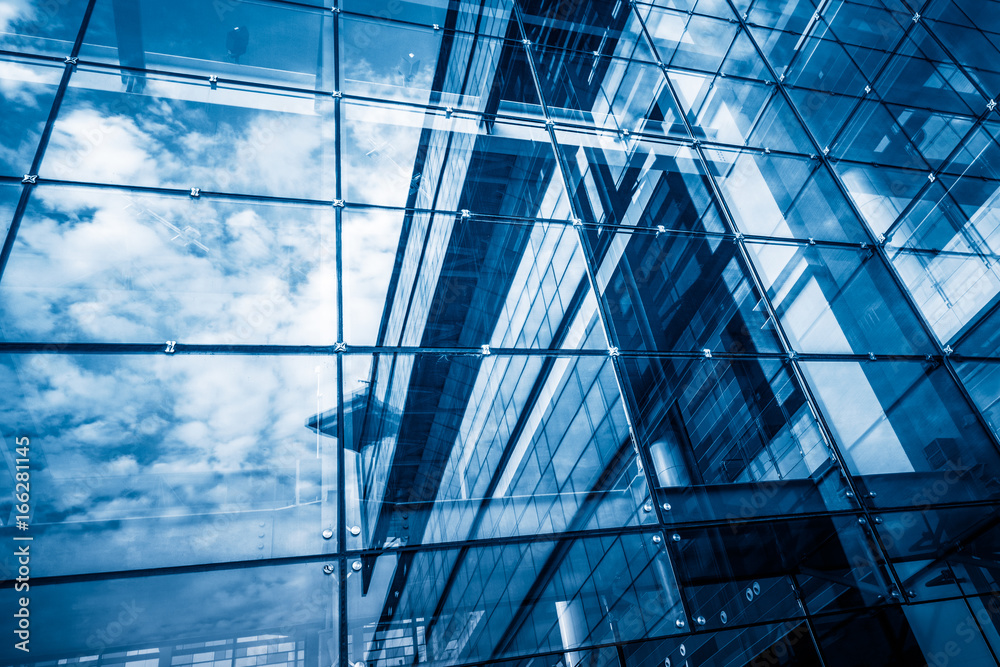modern glass building with reflection,blue toned. modern glass building with reflection,blue toned.