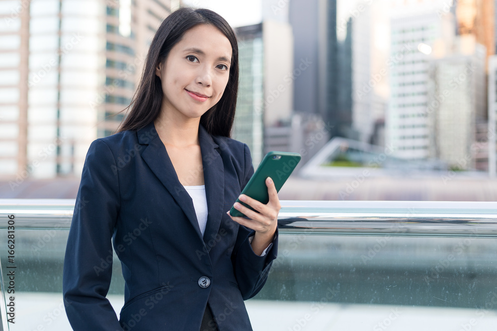 Business woman holding mobile phone