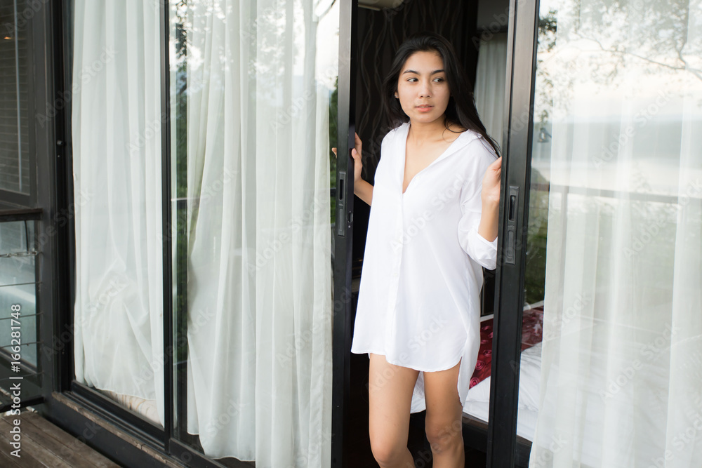 Woman relaxing on balcony in the morning Woman relaxing on balcony in the morning