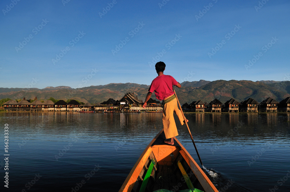Burmese fisherman on boat catching fish in traditional way in Inle lake, Myanmar (Burma), Myanmar travel attraction landmark