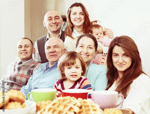 large happy family having tea