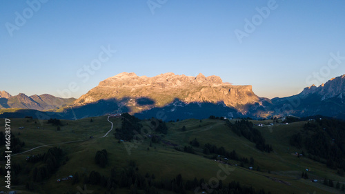 Great landscape on the Dolomites. Drone aerial view on Sella group and Bo peaks during the summer sunrise. Alta Badia, Sud Tirol, Italy