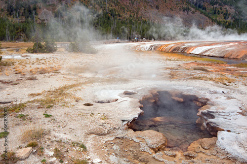 Steam rising out of Hot Spring Geyser in Black Sand Basin in Yellowstone National Park in Wyoming United States