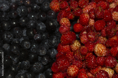 Background of strawberries and blueberries in half