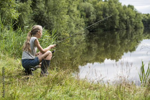 girl fishing at the lake photo