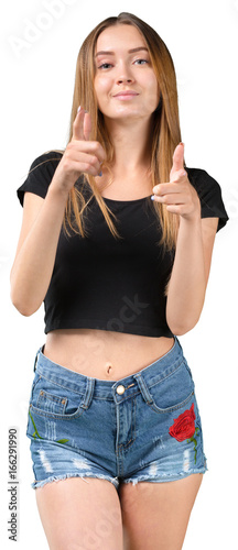 Portrait of a smiling young girl holding finger up