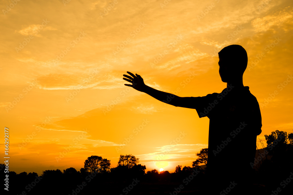the boy hold right hand. action of people silhouette with orange sky in the evening for abstract background.