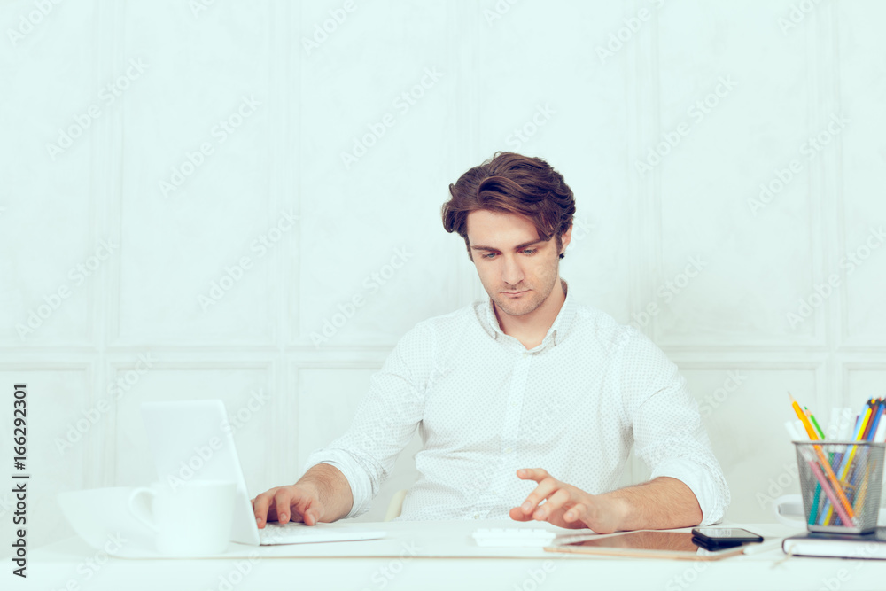 Businessman using laptop with tablet and pen Businessman using laptop with tablet and pen