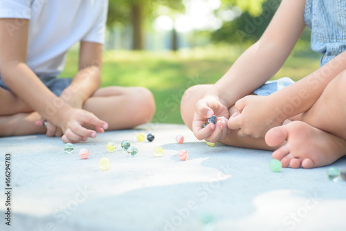 Kids playing marbles game outside