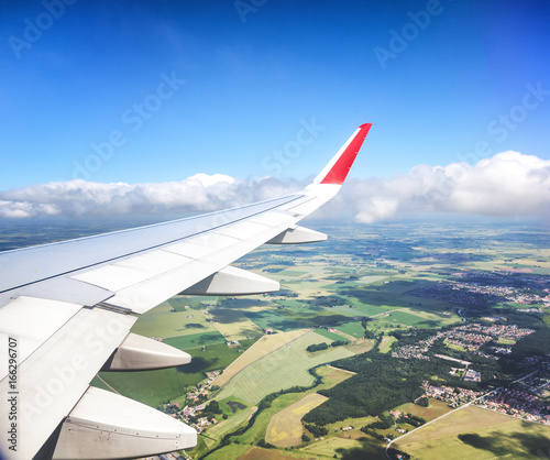 Wing of the aircraft, a view of the fields from above. Travel, freedom, vacations