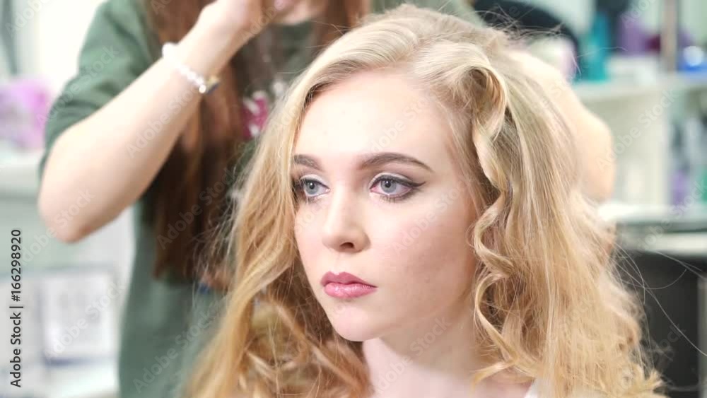 Professional make-up artist prepares a model for a photo shoot Professional make-up artist prepares a model for a photo shoot