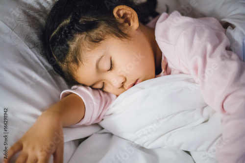 Little child girl sleeping in the bed