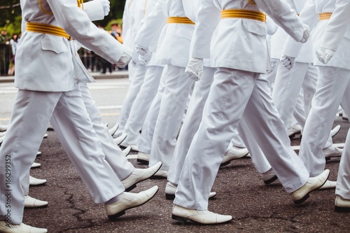 military men  in white uniform marching to victory parade