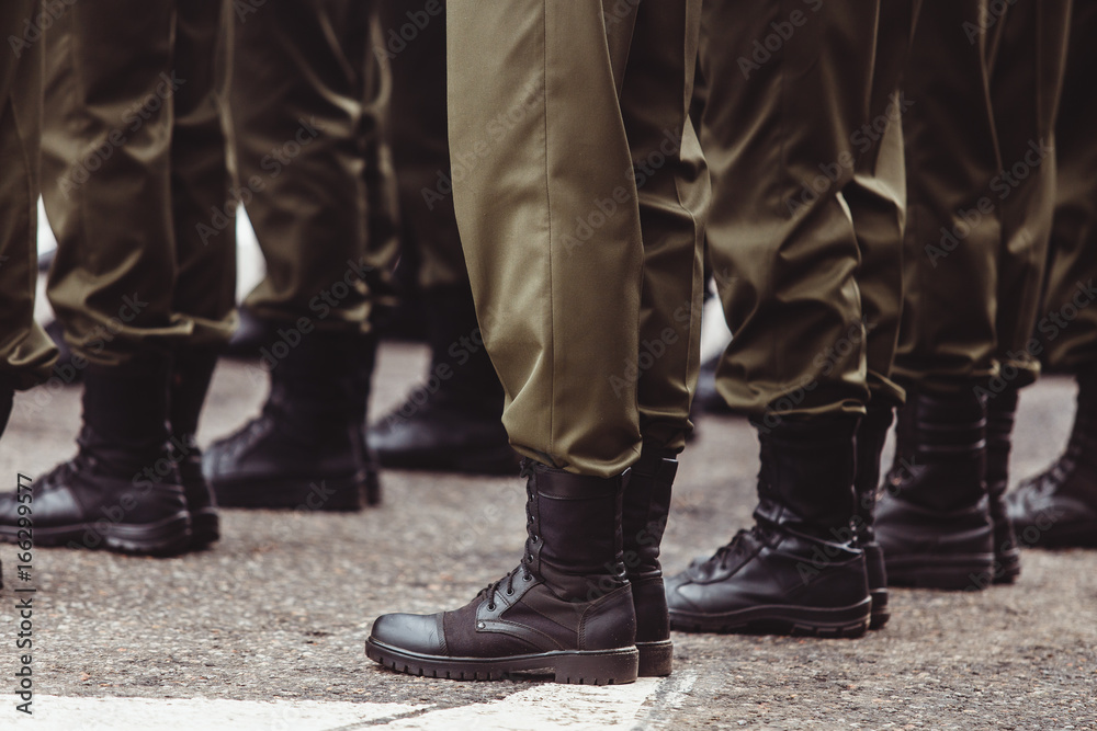 military men in green dress uniform stand at attention