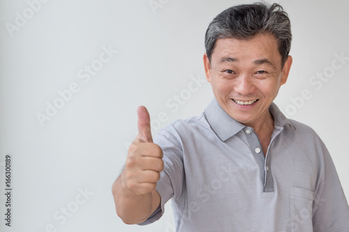 happy, successful, positive middle aged man showing thumb up