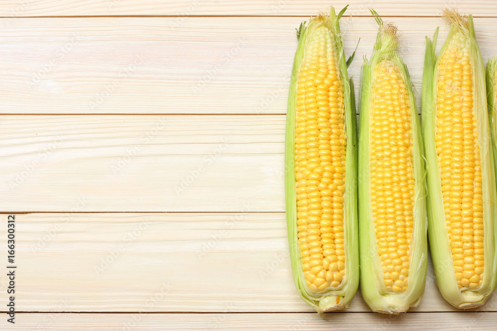 Fresh corn on cob on wooden table. Top view with copy space Fresh corn on cob on wooden table. Top view with copy space