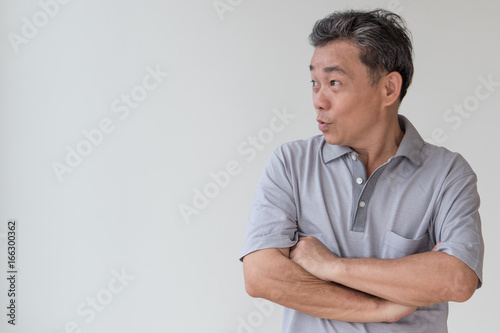 exited, confident, happy smiling old senior or middle age asian man looking away to blank space