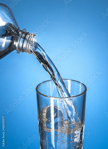 Bottle of Water Pouring in A Glass