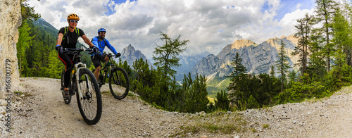 Mountain biking couple with bikes on track  Cortina d Ampezzo  Dolomites  Italy