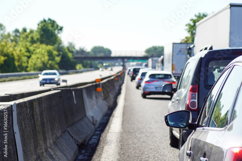 blured image of traffic jam on the road and opposite side of the road is empty