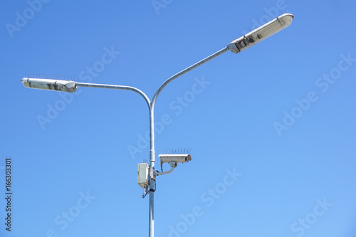 surveillance camera on light pole in parking lot