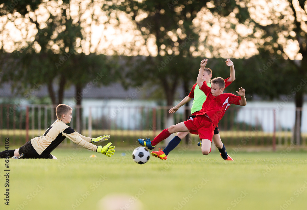 Obraz premium Kids soccer football - children players match on soccer field