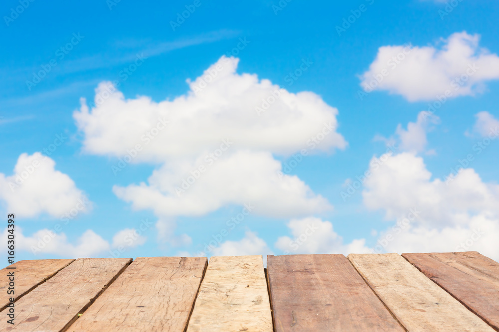 perspective old wooden board empty table in front of blur background of bright cloudy sky, can be used for display or montage your products. Mock up for displaying product. perspective old wooden board empty table in front of blur background of bright cloudy sky, can be used for display or montage your products. Mock up for displaying product.