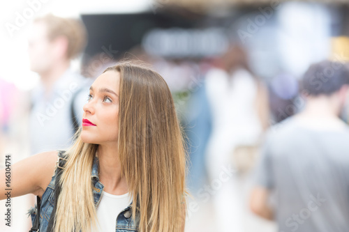 Beautiful teenager girl looking up, close up photo with defocused copy space background