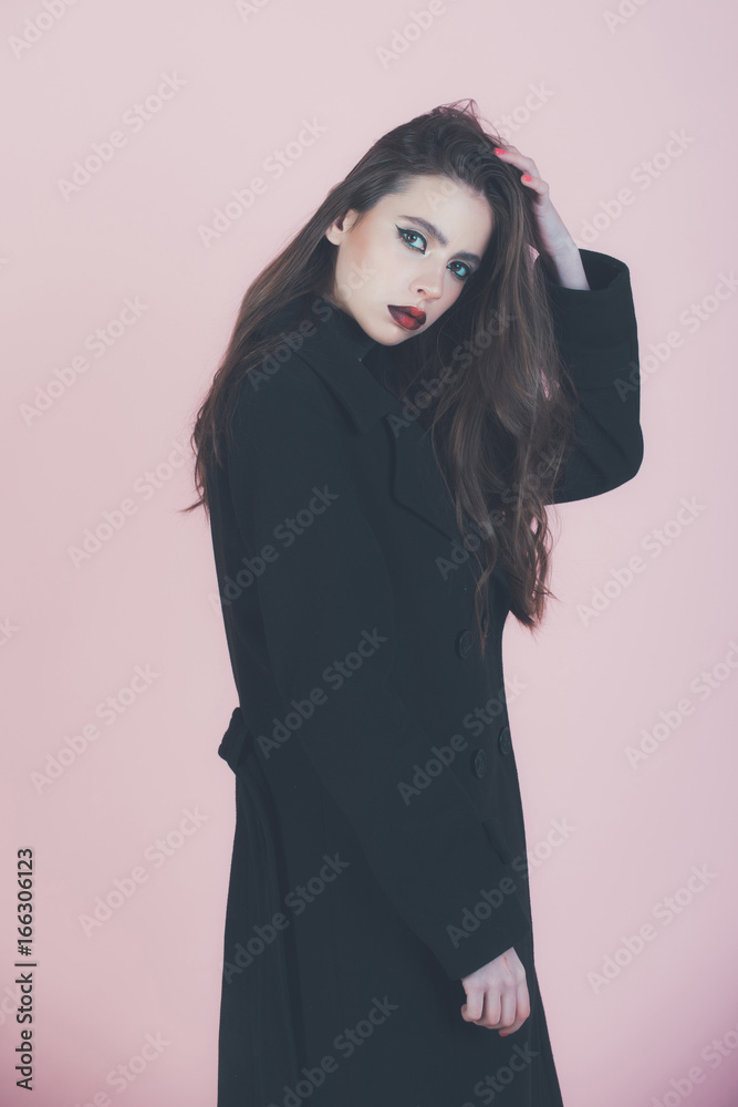 Girl with fashionable makeup in coat.