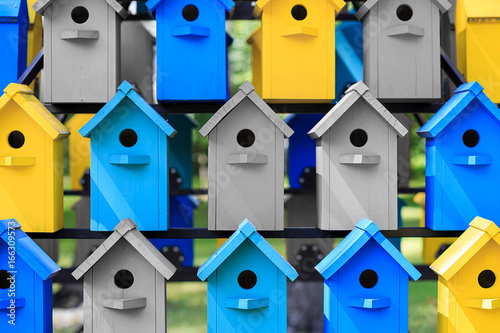 background of colorful yellow-blue houses for birds, the concept of animal protection