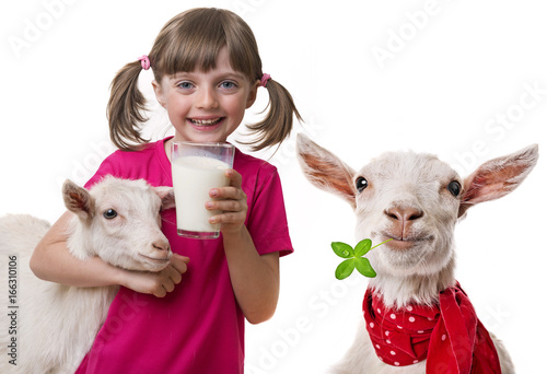 little girl drinking healthy goat milk isolated on white background