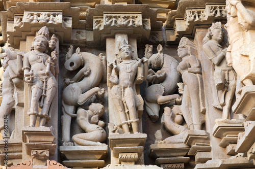 Ancient reliefs at famous temple in Khajuraho, India photo