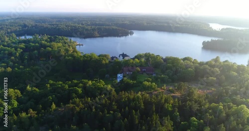 Fagervik, Cinema 4k aerial view around yellow mansion and fagervik steelworks, at a sunny evening, in Inkoo, Uusimaa, Finland photo