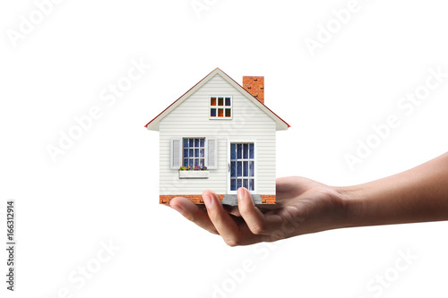 Mortgage concept by house from  hand