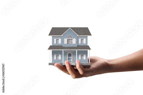 Mortgage concept by house from  hand