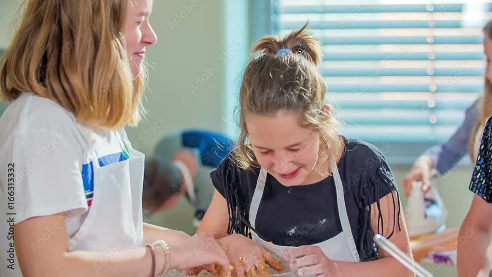 Students in the cooking class in school are having a lot of fun. They are eating the dough when making a chocolate cake. Students in the cooking class in school are having a lot of fun. They are eating the dough when making a chocolate cake.