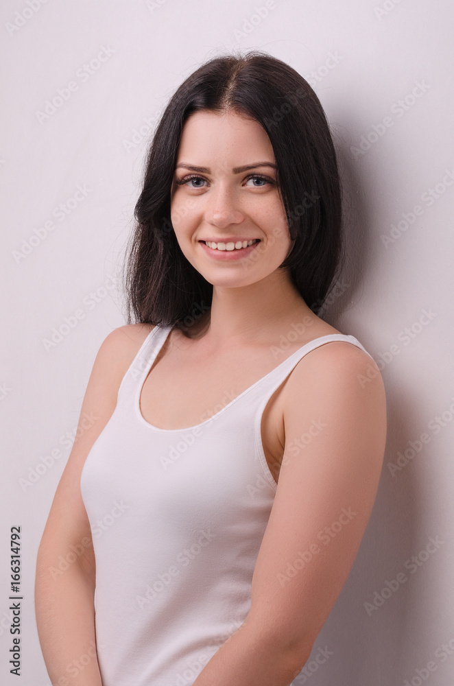 Young attractive girl smiling on a white background. Portrait. Beautiful woman. Young attractive girl smiling on a white background. Portrait. Beautiful woman.