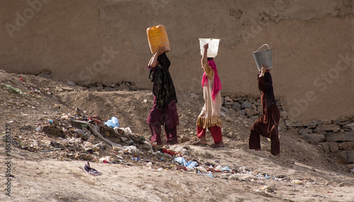 Women carrying water in Kabul, Afghanistan photo