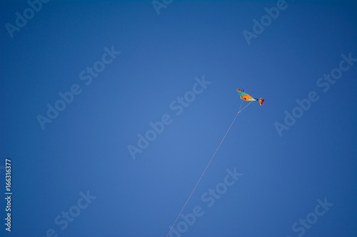 Color Kite over blue sky without clouds, background