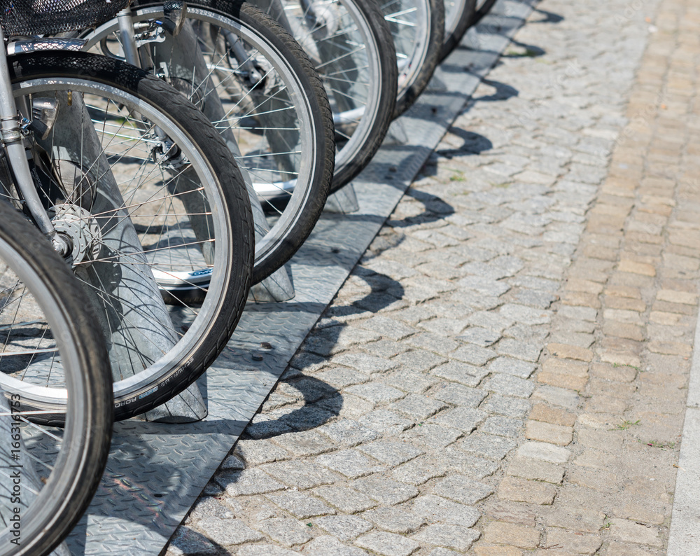 close up on bike wheels in row