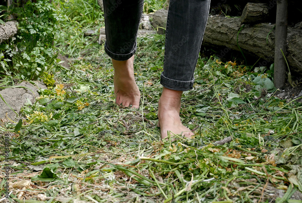 Girl walking barefoot in the garden Girl walking barefoot in the garden